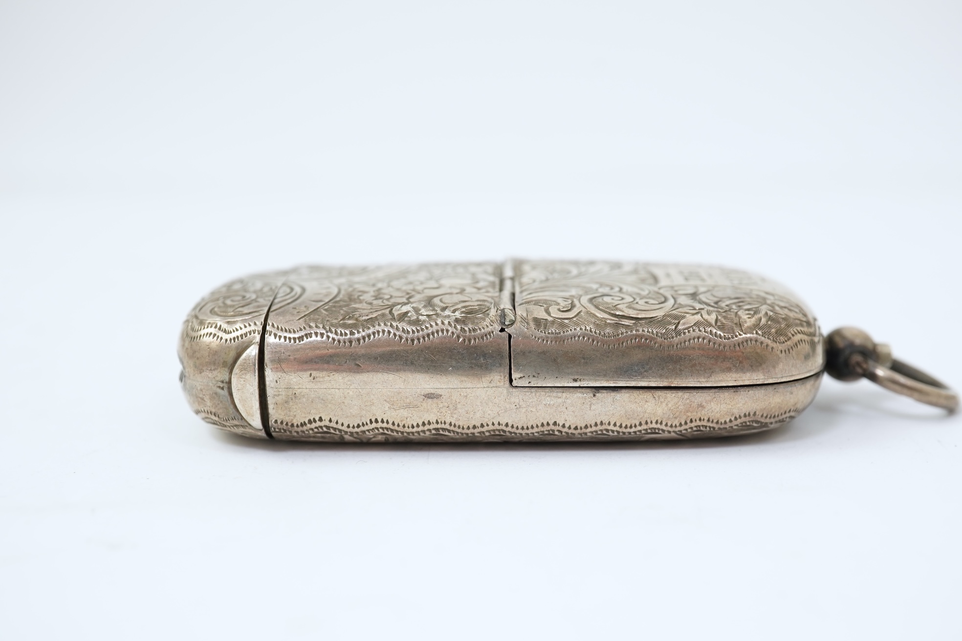 A late Victorian engraved silver oval combination sovereign and vesta case, by JW